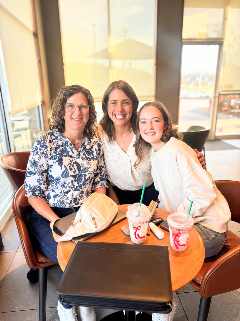 wedding coordinator meeting with bride and mother of bride at coffee shop